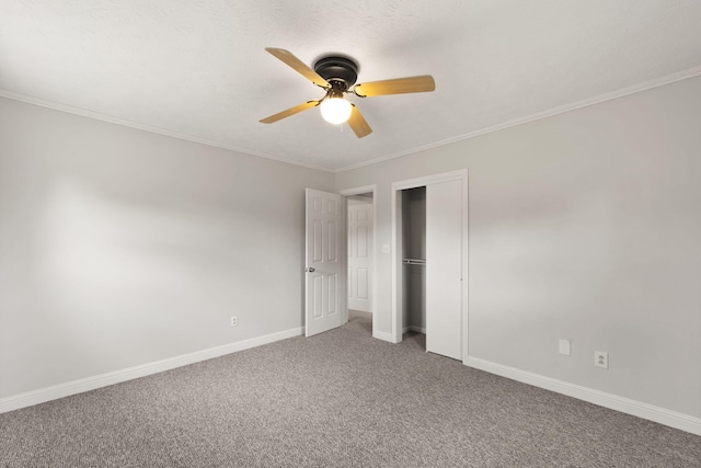 unfurnished bedroom featuring ornamental molding, carpet flooring, a closet, and ceiling fan