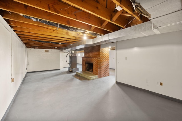 basement with heating unit and a brick fireplace