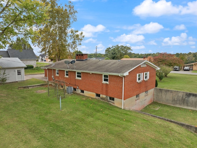 back of property featuring a lawn and central AC unit