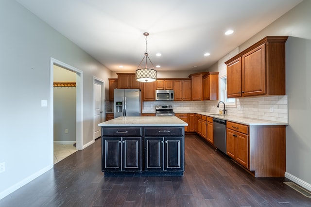 kitchen with sink, a center island, dark hardwood / wood-style flooring, stainless steel appliances, and pendant lighting