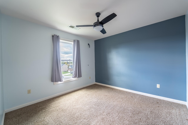 carpeted spare room with ceiling fan