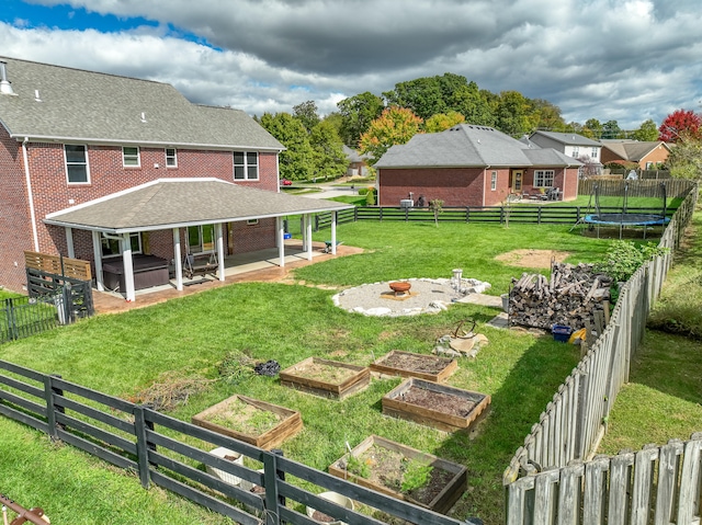 view of yard featuring a patio area and a trampoline