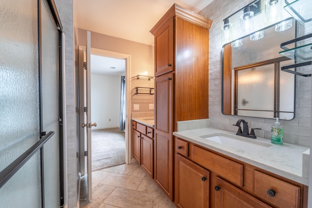 bathroom with vanity, walk in shower, tile patterned floors, and backsplash