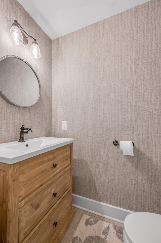 bathroom featuring vanity and toilet