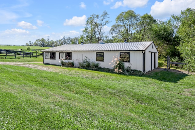 exterior space featuring a front lawn and a rural view