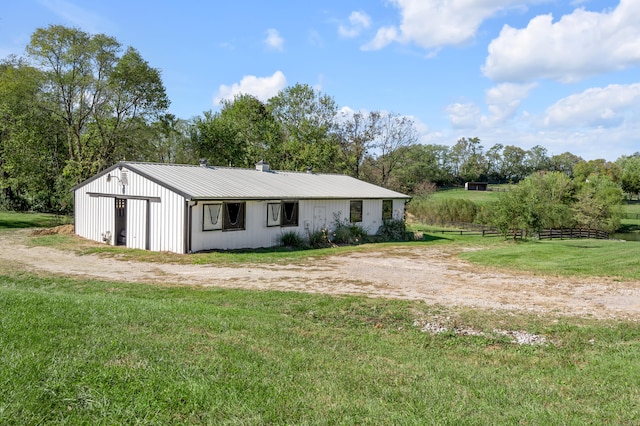 exterior space with a front yard and an outbuilding