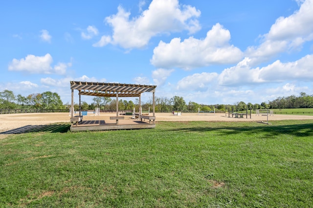 surrounding community featuring a rural view, a wooden deck, a lawn, and a pergola