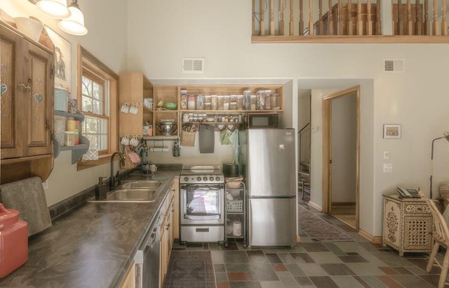 kitchen featuring a sink, stainless steel countertops, visible vents, and stainless steel appliances