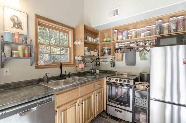 kitchen with open shelves, stainless steel appliances, visible vents, and a sink