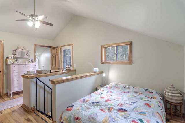 bedroom featuring lofted ceiling and light wood-style floors