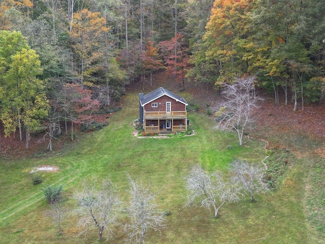 birds eye view of property featuring a wooded view