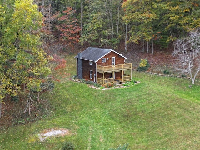 drone / aerial view with a wooded view