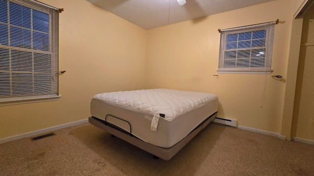 bedroom featuring ceiling fan, carpet floors, and baseboard heating