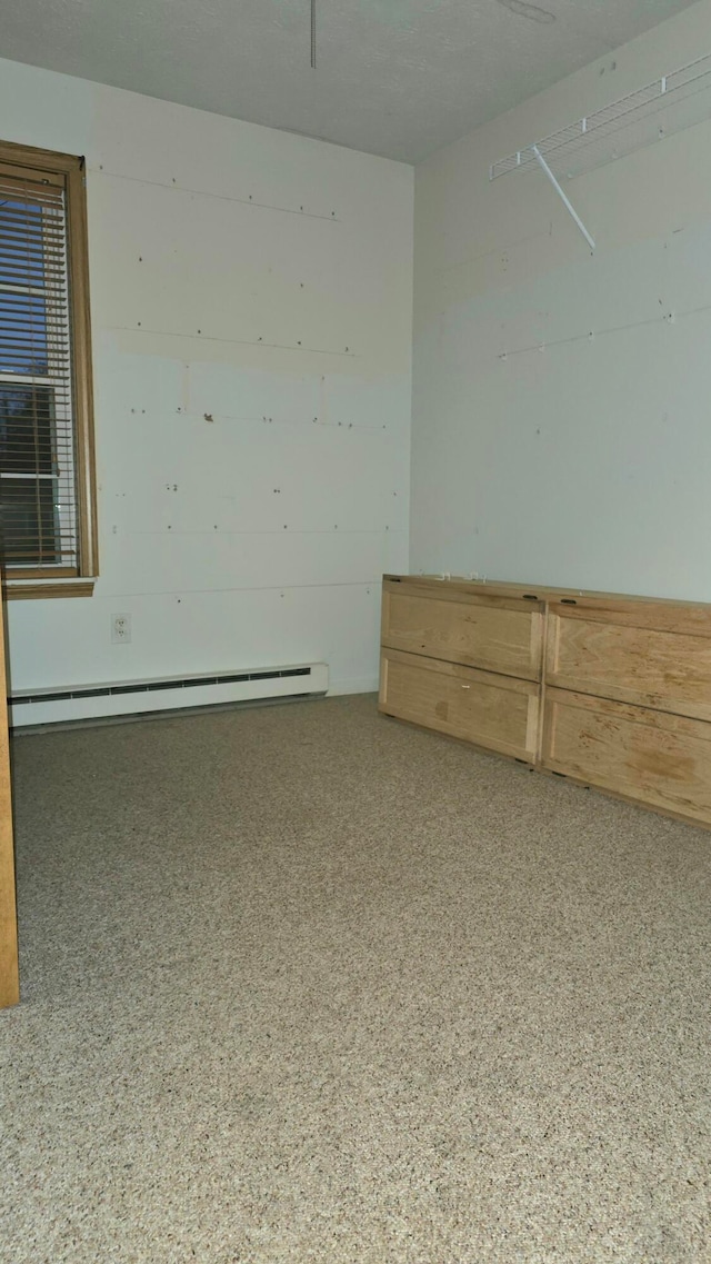 unfurnished room featuring a baseboard heating unit