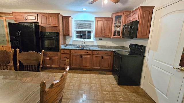 kitchen with black appliances, ceiling fan, and sink