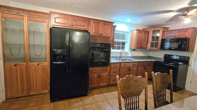 kitchen featuring sink, light parquet floors, ceiling fan, and black appliances