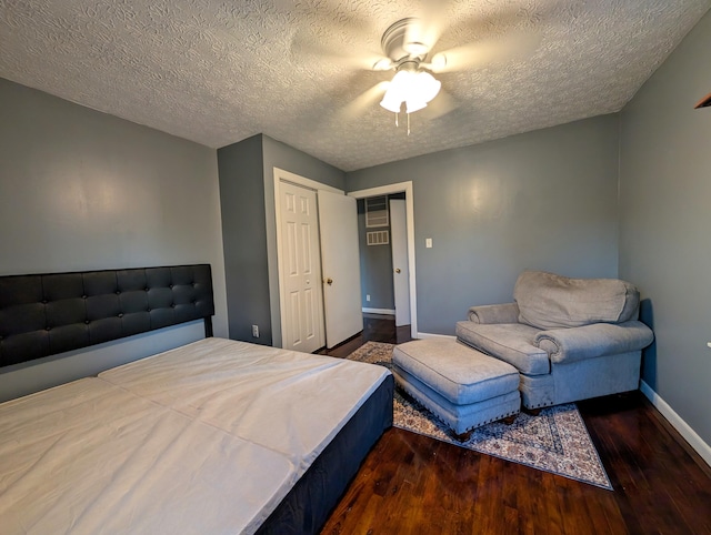 bedroom with a closet, ceiling fan, a textured ceiling, and dark hardwood / wood-style flooring