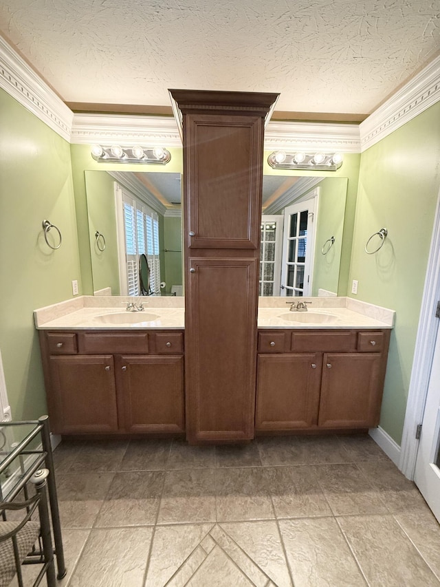 bathroom featuring a textured ceiling, vanity, and crown molding