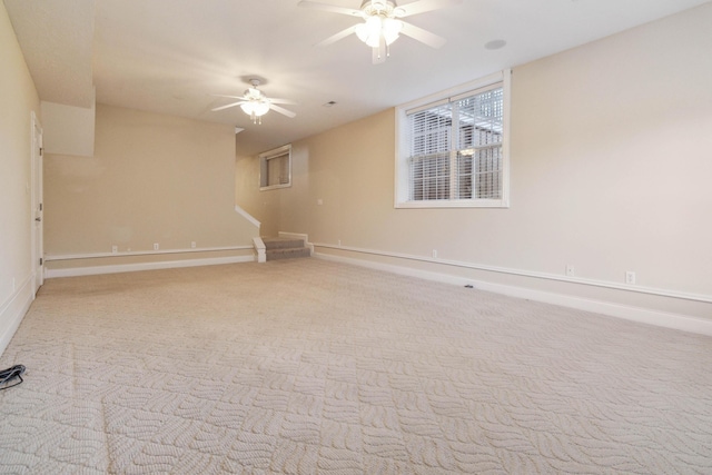 empty room with ceiling fan and light colored carpet