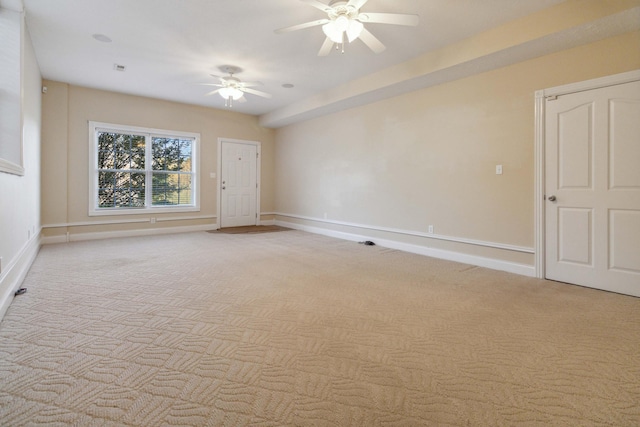 spare room with ceiling fan and light colored carpet