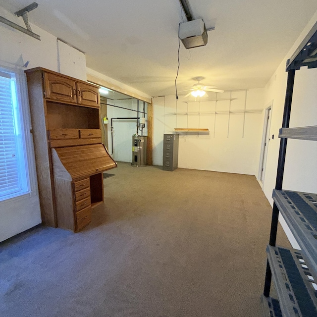 garage featuring ceiling fan, electric water heater, and a garage door opener