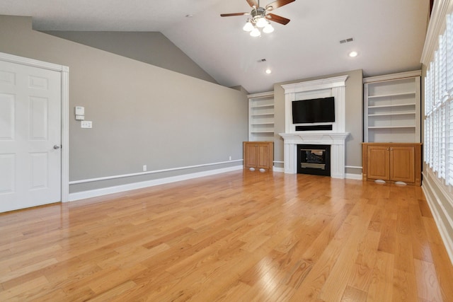 unfurnished living room featuring ceiling fan, light hardwood / wood-style floors, and vaulted ceiling