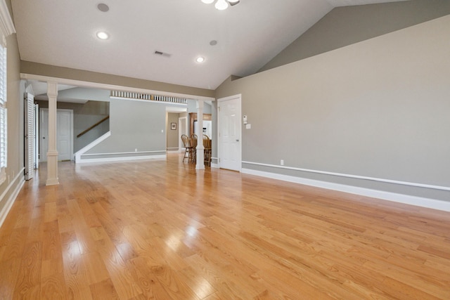 unfurnished living room featuring vaulted ceiling and light wood-type flooring