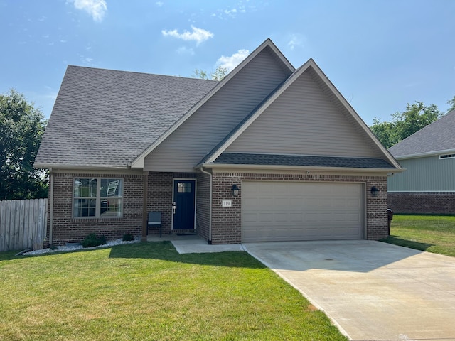 view of front of house with a front yard and a garage