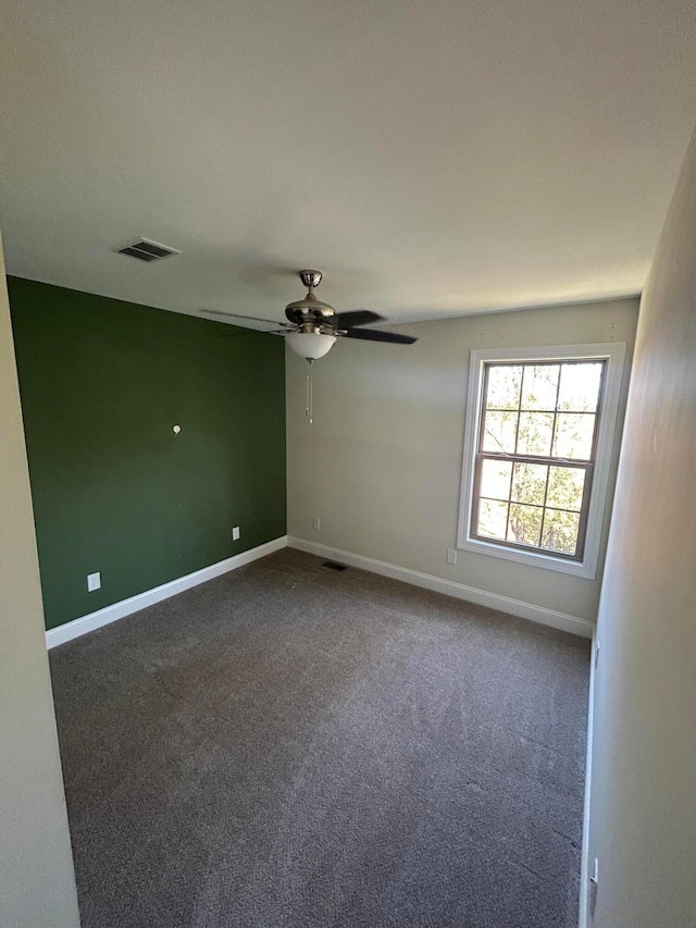 spare room featuring carpet flooring and ceiling fan