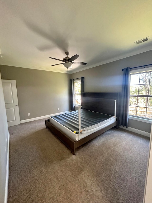 unfurnished bedroom featuring ornamental molding, carpet, and ceiling fan