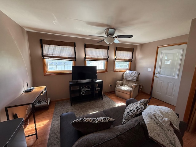 living room with light hardwood / wood-style flooring and ceiling fan