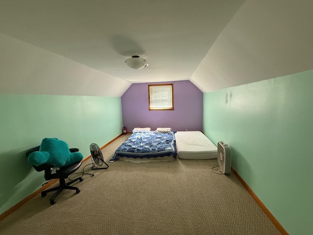 unfurnished bedroom featuring carpet and vaulted ceiling