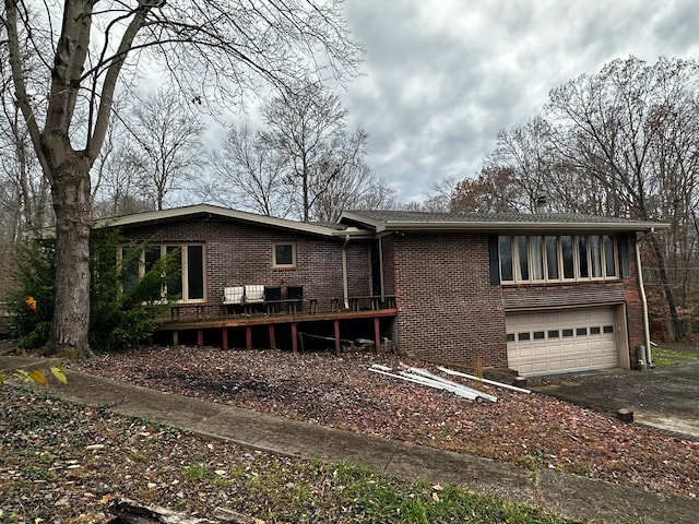 view of front of home with a garage and a wooden deck