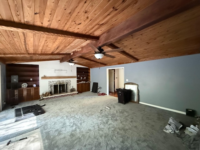 unfurnished living room featuring ceiling fan, vaulted ceiling with beams, a stone fireplace, carpet floors, and wood ceiling