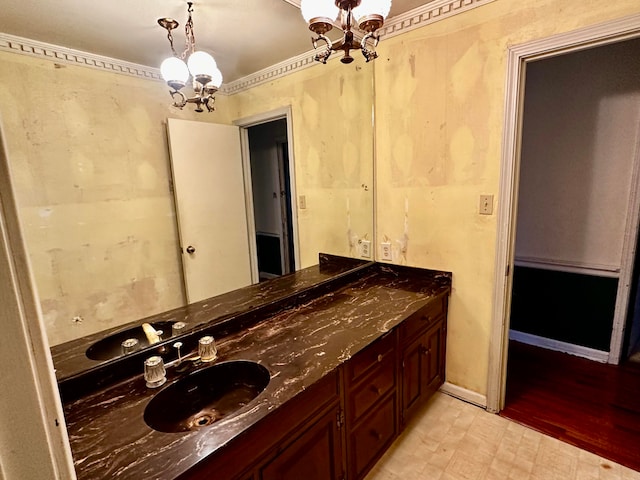 bathroom with hardwood / wood-style flooring, vanity, and an inviting chandelier