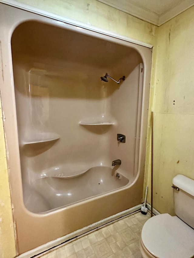 bathroom featuring tub / shower combination and toilet