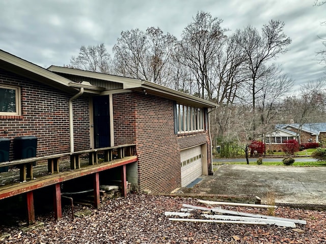 view of side of home featuring a wooden deck and a garage