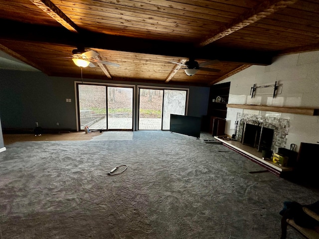 unfurnished living room with vaulted ceiling with beams, wood ceiling, and carpet floors