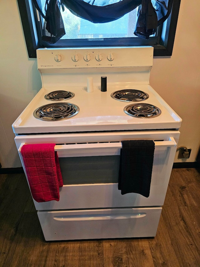 interior details with electric range and dark hardwood / wood-style flooring