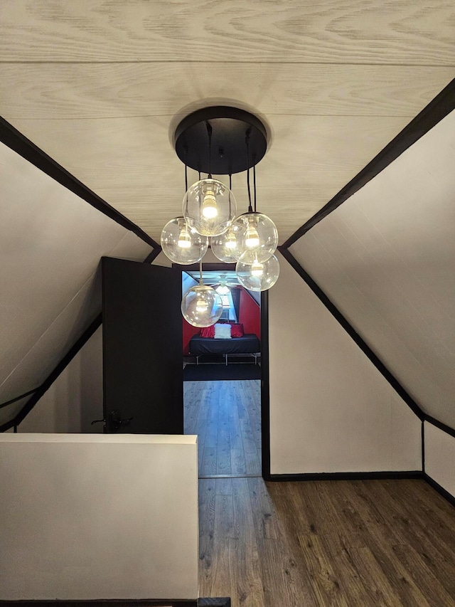 unfurnished dining area featuring hardwood / wood-style floors and vaulted ceiling