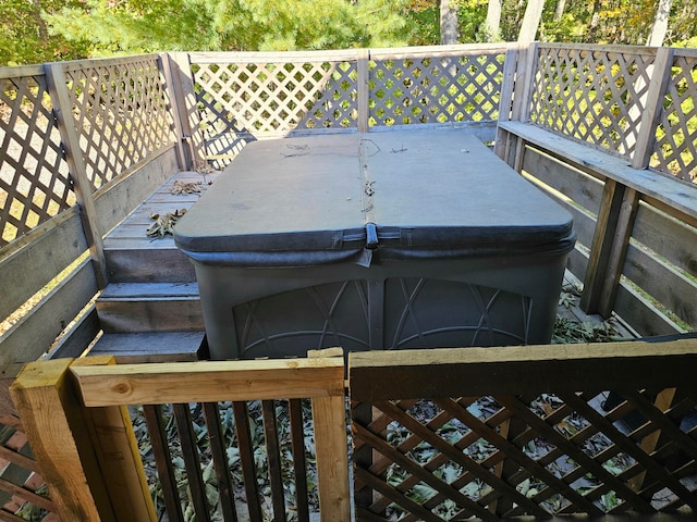 wooden deck featuring a hot tub