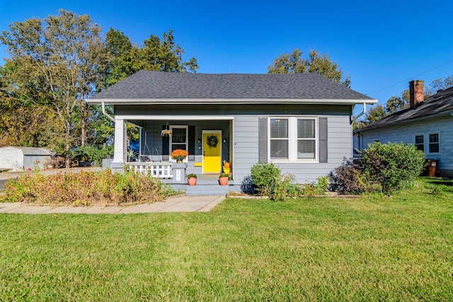 bungalow with a porch and a front yard