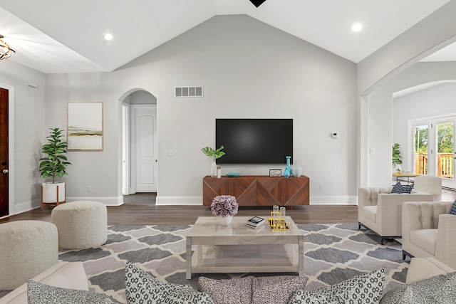 living room with dark hardwood / wood-style floors and high vaulted ceiling