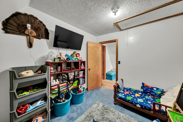 rec room featuring a textured ceiling and light colored carpet