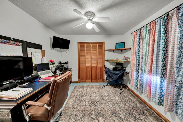 office space featuring a textured ceiling and ceiling fan