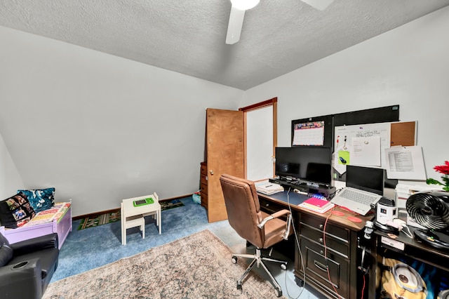 carpeted home office with a textured ceiling and ceiling fan