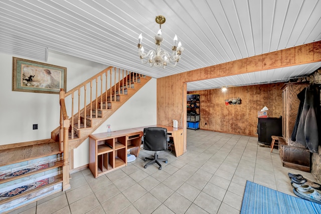 tiled office with an inviting chandelier, wood walls, and wooden ceiling