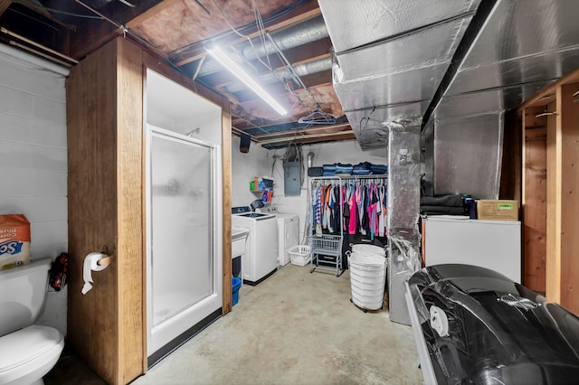 basement with electric panel and independent washer and dryer