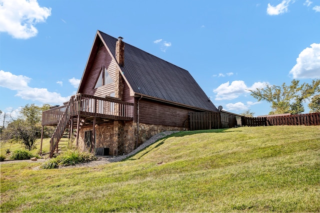 view of home's exterior featuring a yard and a deck