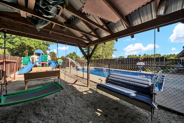 view of pool with a playground